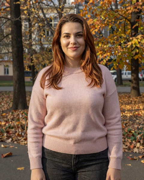 Natalia in soft pink cashmere sweater in a Chișinău autumn park in golden afternoon light