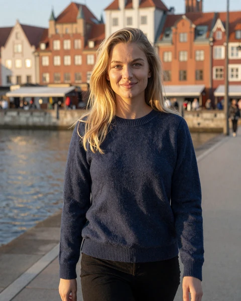 Natalia from Gdańsk in navy sweater walking along the harbor waterfront