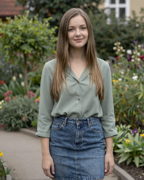 Zuzana from Kosice in sage blouse in a botanical garden